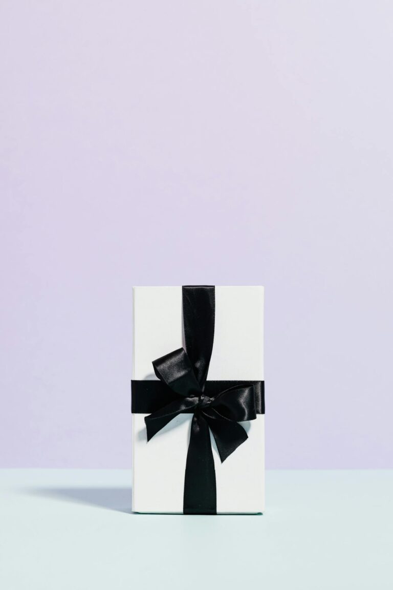 A minimalist white gift box with a black ribbon, perfect for celebrations and special occasions.